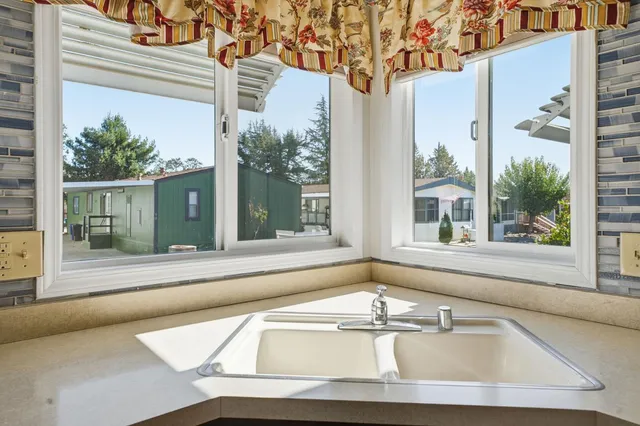 a white bath tub sitting in front of a window