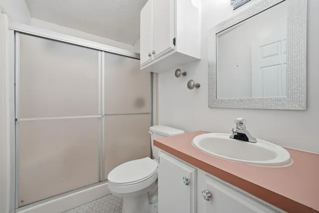 a bathroom with a sink toilet and shower