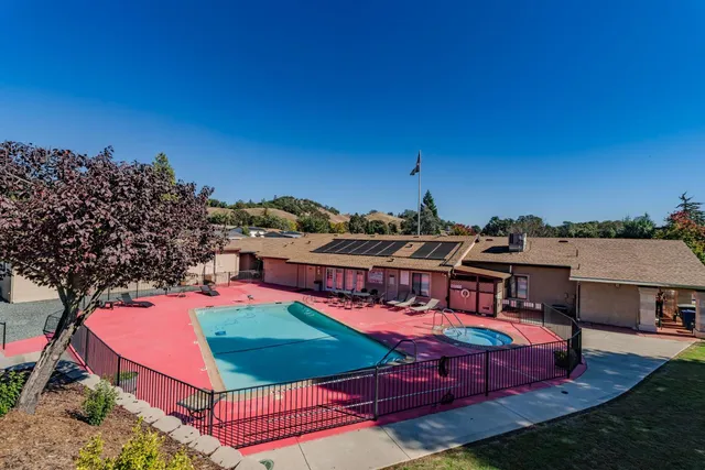 an aerial view of a house with swimming pool yard and outdoor seating