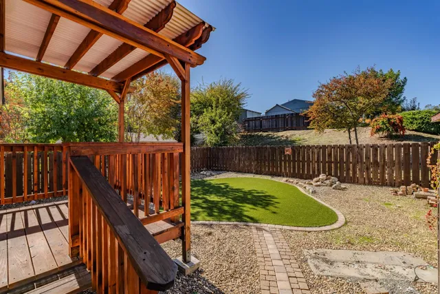 a view of a roof deck with wooden fence and wooden fence