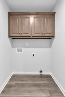 a view of a kitchen with wooden floor and cabinets