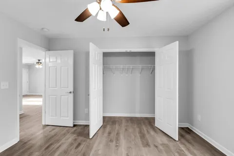 a view of an empty room and wooden floor