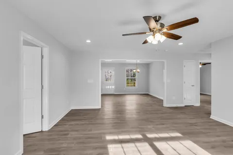 a view of a livingroom with wooden floor and window
