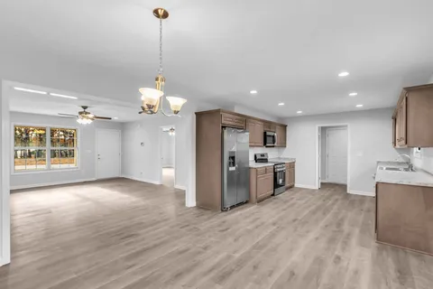 a view of a kitchen with a sink and a large window