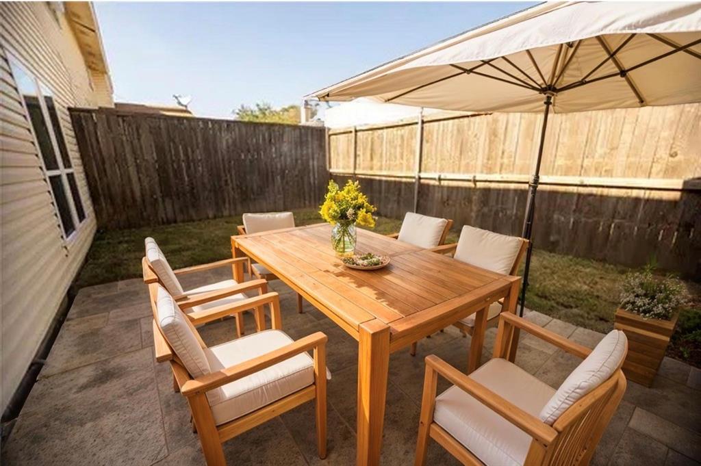 733 Intrepid Drive Garland, TX 75043 - Photo 24 of 25 Fenced backyard featuring a patio and outdoor dining space.