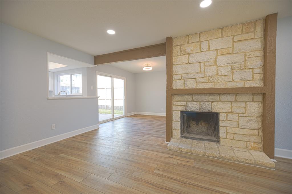733 Intrepid Drive Garland, TX 75043 - Photo 6 of 25 living room with a fireplace, wood finished floors, and recessed lighting