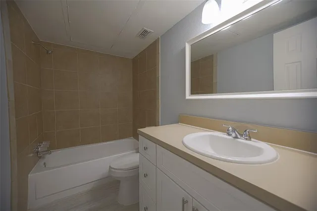 a bedroom with a large bed and a potted plant