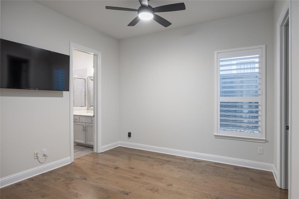 918 Sydney Lane Allen, TX 75013 - Photo 20 of 40 Guest Bed room features hardwood floors, a ceiling fan with integrated lighting, and a window with plantation shutters