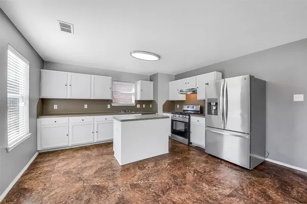 an empty room with fan and windows