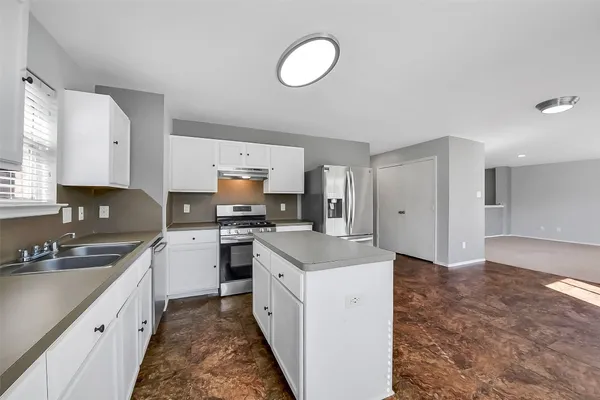 a view of a kitchen with a sink and a window