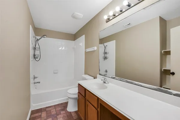 a view of an empty room with window and fire place
