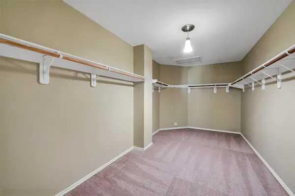 a bedroom with bed and a chandelier