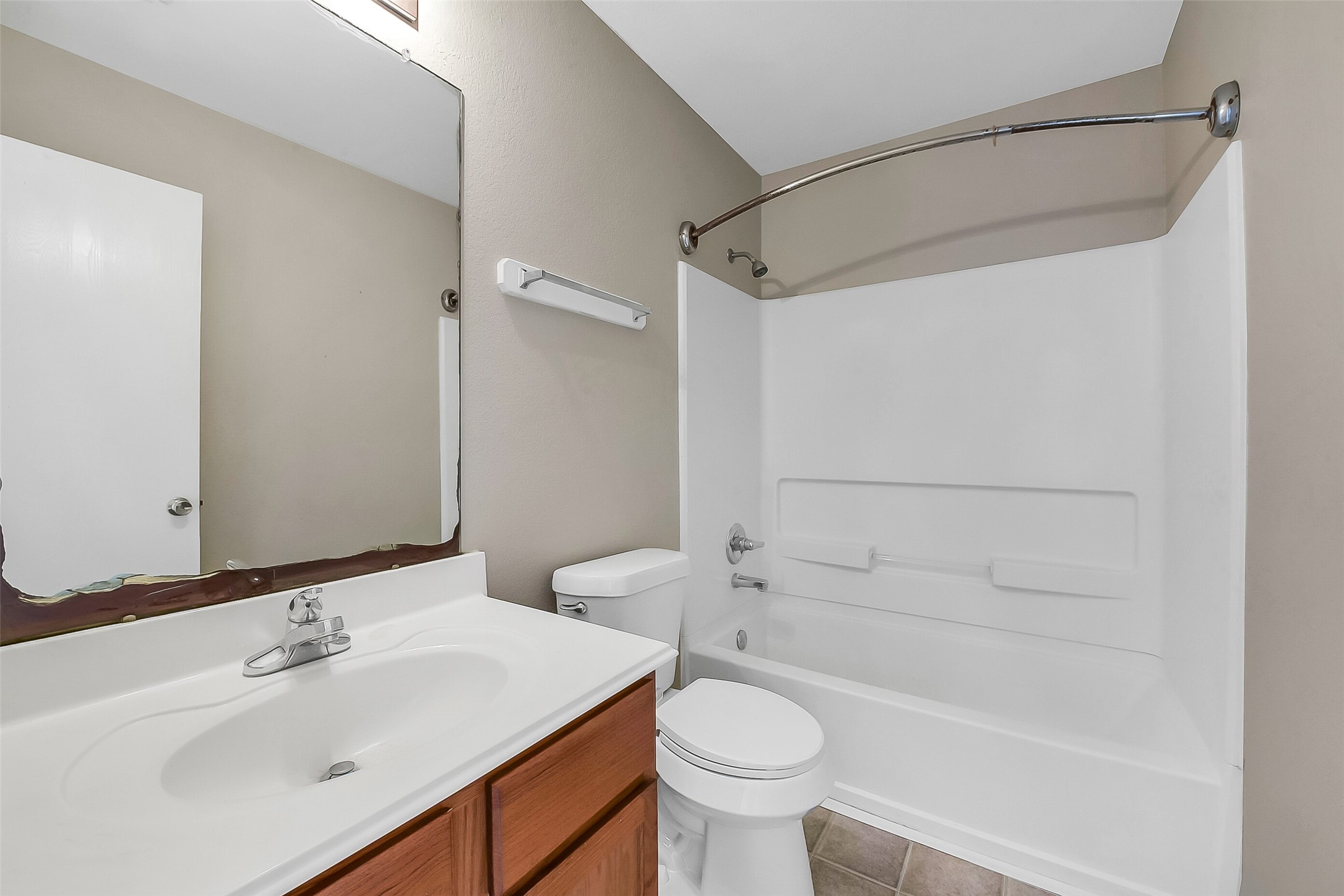 20011 Spring Wreath Lane Cypress, TX 77433 - Photo 32 of 39 Clean full bath with a tub/shower combo and vanity storage.