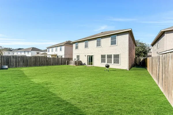 a view of a big room with windows and ceiling fan
