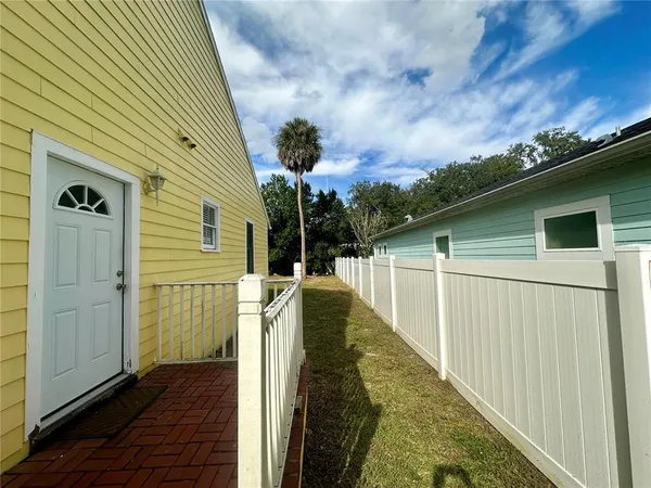 a view of a house with a backyard