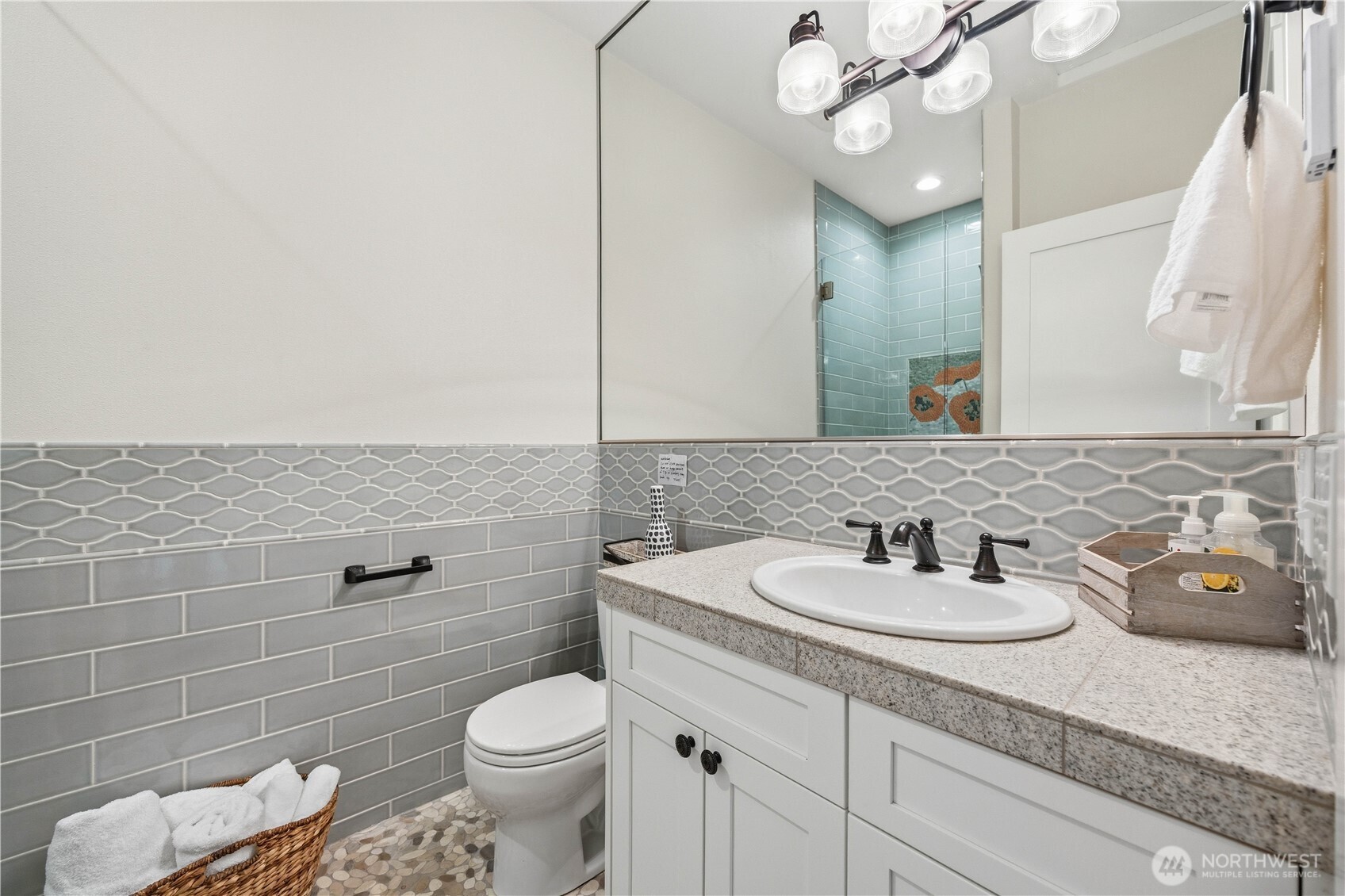 141 Sunset Place Manson, WA 98831 - Photo 22 of 38 a bathroom with a granite countertop toilet sink and mirror