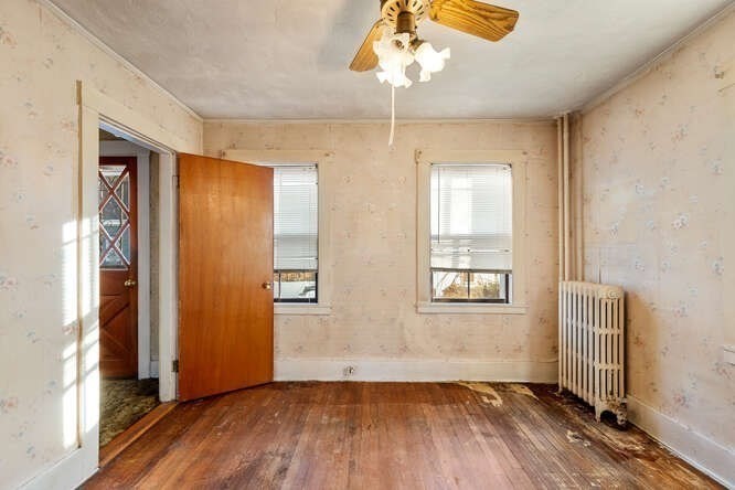 13 Highland Street Wakefield, MA 01880 - Photo 12 of 35 wooden floor in an empty room with a window