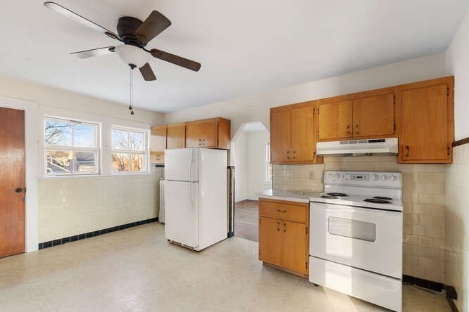 13 Highland Street Wakefield, MA 01880 - Photo 16 of 35 a kitchen with a stove cabinets and refrigerator