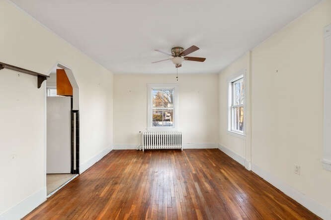 13 Highland Street Wakefield, MA 01880 - Photo 24 of 35 a view of empty room with wooden floor and fan