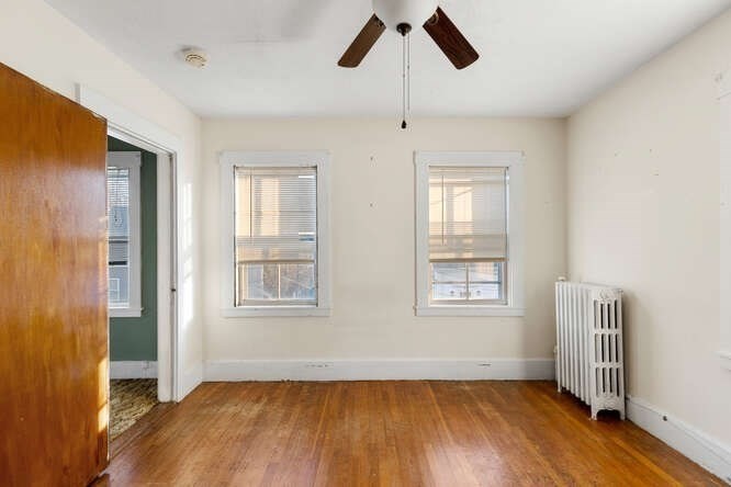 13 Highland Street Wakefield, MA 01880 - Photo 26 of 35 a view of an empty room with wooden floor and a window
