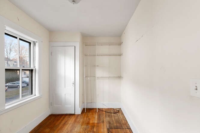 13 Highland Street Wakefield, MA 01880 - Photo 27 of 35 an empty room with wooden floor and windows