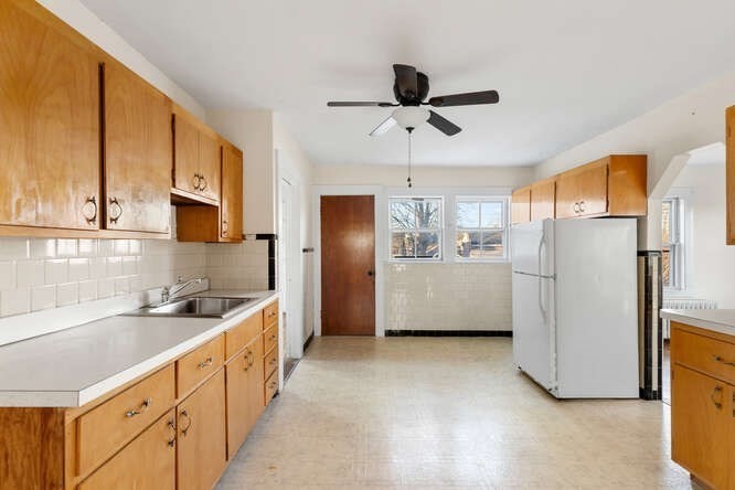 13 Highland Street Wakefield, MA 01880 - Photo 4 of 35 a kitchen with stainless steel appliances a refrigerator sink and cabinets