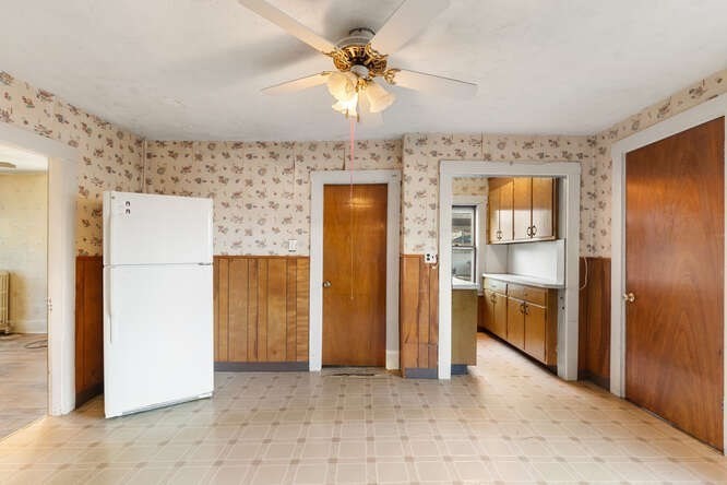 13 Highland Street Wakefield, MA 01880 - Photo 8 of 35 a view of a kitchen with a refrigerator a sink a cabinet and a refrigerator