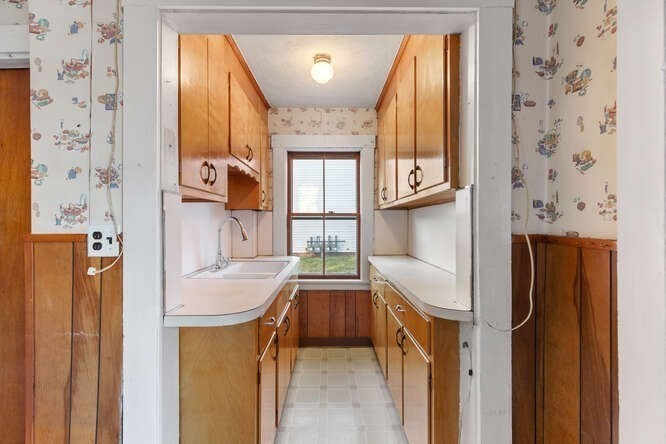 13 Highland Street Wakefield, MA 01880 - Photo 9 of 35 a kitchen with a sink a refrigerator and window