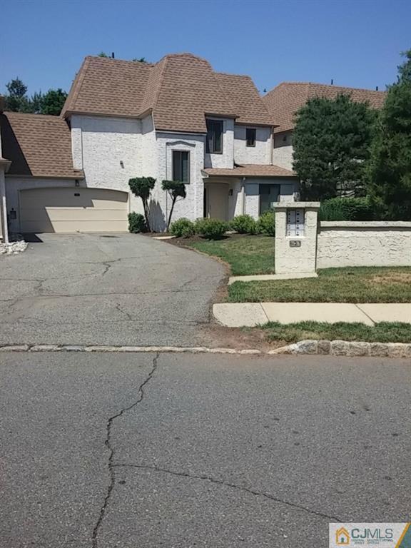 75 Park Gate Drive Edison, NJ 08820 - Photo 2 of 19 a front view of a house with a yard and garage