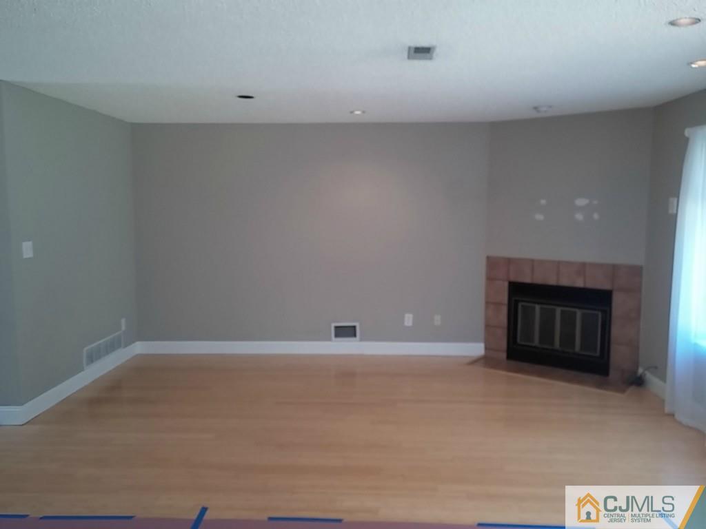 75 Park Gate Drive Edison, NJ 08820 - Photo 4 of 19 a view of an empty room with a fireplace