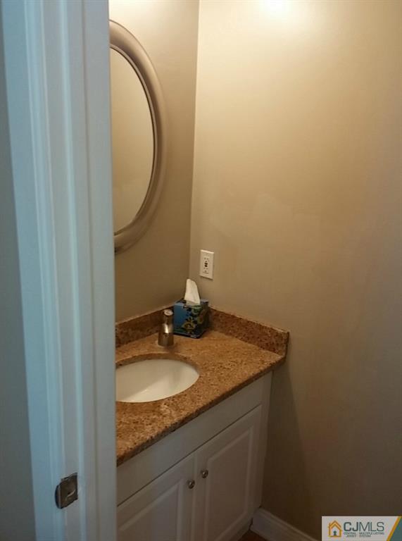 75 Park Gate Drive Edison, NJ 08820 - Photo 8 of 19 a bathroom with a granite countertop sink and a mirror