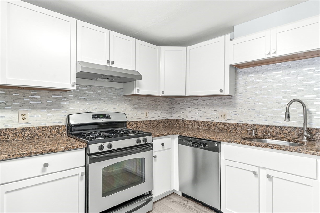 14 Centercrest Drive, Unit 14 Tyngsborough, MA 01879 - Photo 11 of 27 a kitchen with granite countertop white cabinets and appliances