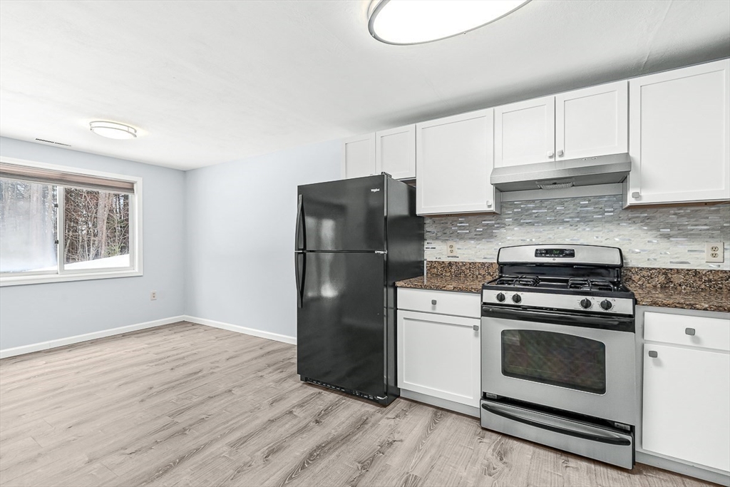 14 Centercrest Drive, Unit 14 Tyngsborough, MA 01879 - Photo 12 of 27 a kitchen with a stove a refrigerator and a sink