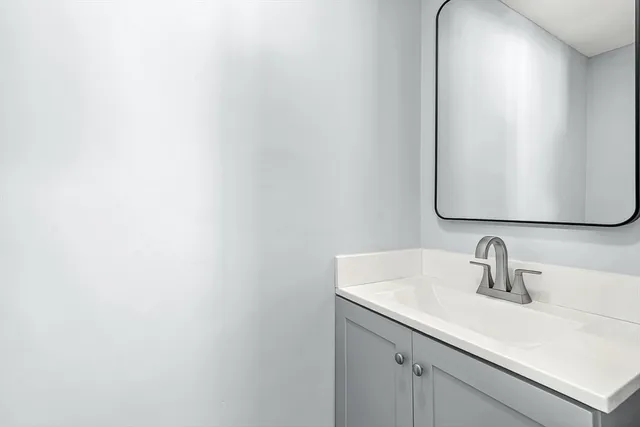 a bathroom with a sink and mirror