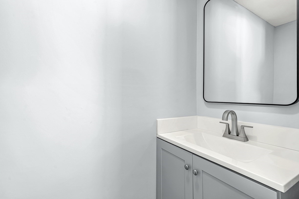 14 Centercrest Drive, Unit 14 Tyngsborough, MA 01879 - Photo 13 of 27 a bathroom with a sink and mirror