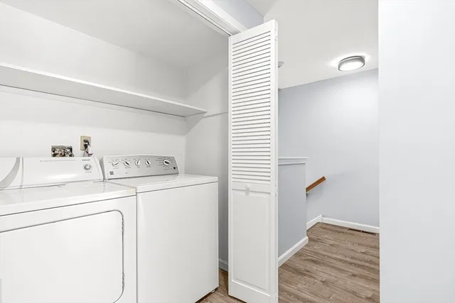 a view of washer and dryer with kitchen in the background