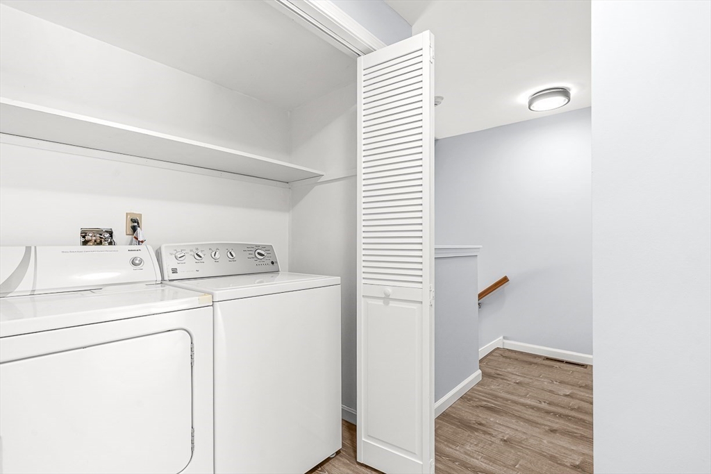 14 Centercrest Drive, Unit 14 Tyngsborough, MA 01879 - Photo 17 of 27 a view of washer and dryer with kitchen in the background