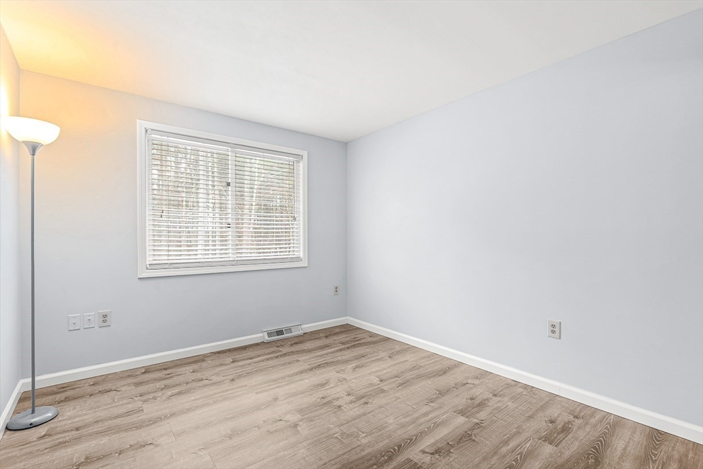 14 Centercrest Drive, Unit 14 Tyngsborough, MA 01879 - Photo 18 of 27 wooden floor in an empty room with a window