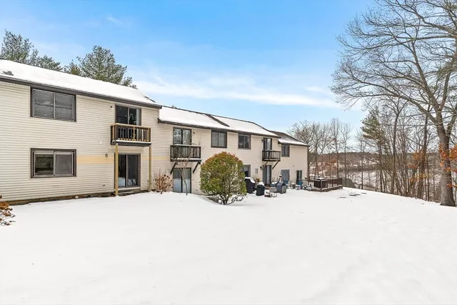 a front view of a house with a yard covered in snow