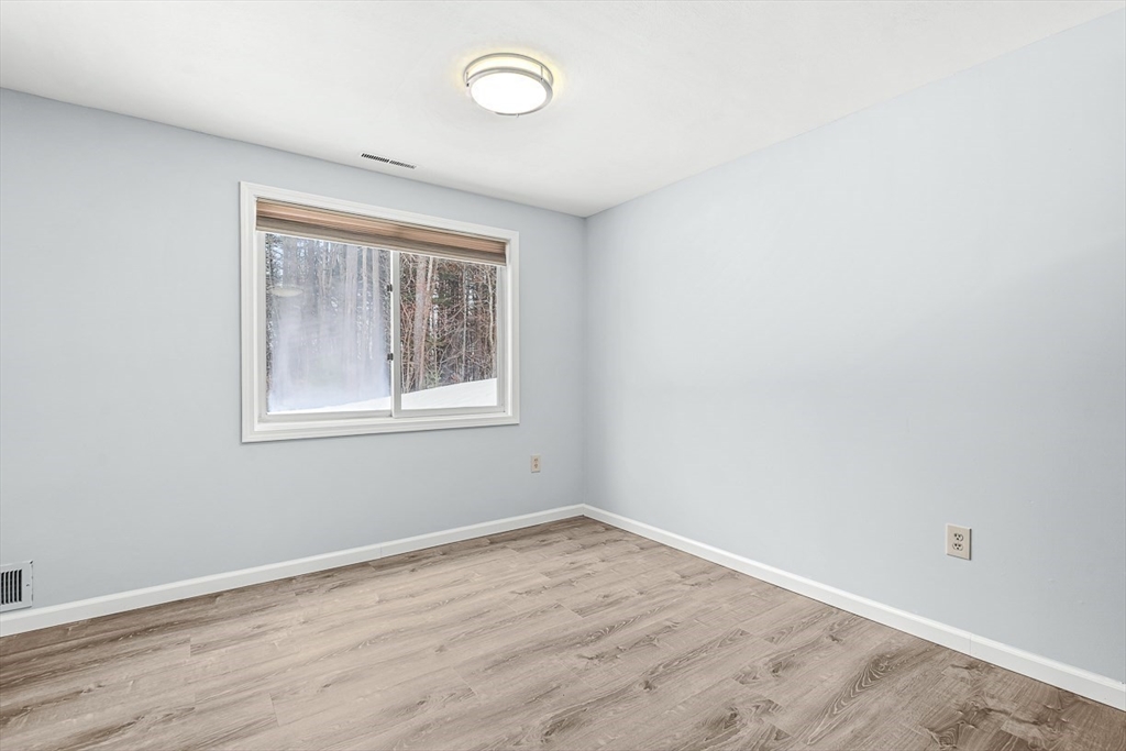 14 Centercrest Drive, Unit 14 Tyngsborough, MA 01879 - Photo 9 of 27 wooden floor in an empty room with a window