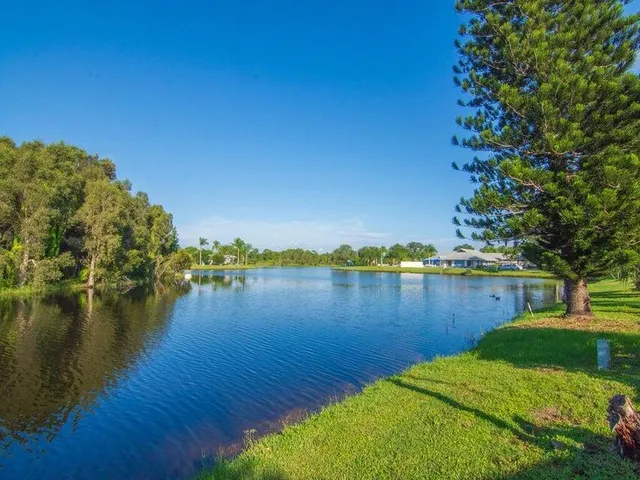 a view of a lake with houses in the back