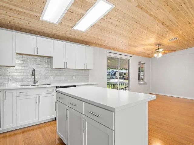 a kitchen with a sink cabinets and window