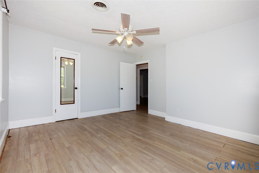 9903 Boze Road Ford, VA 23850 - Photo 21 of 45 an empty room with wooden floor closet and fan