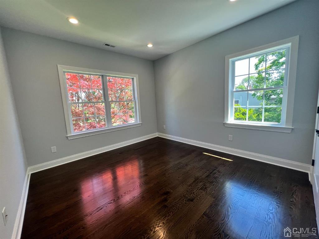 133 Old Beekman Road Monmouth Junction, NJ 08852 - Photo 15 of 42 an empty room with wooden floor and windows