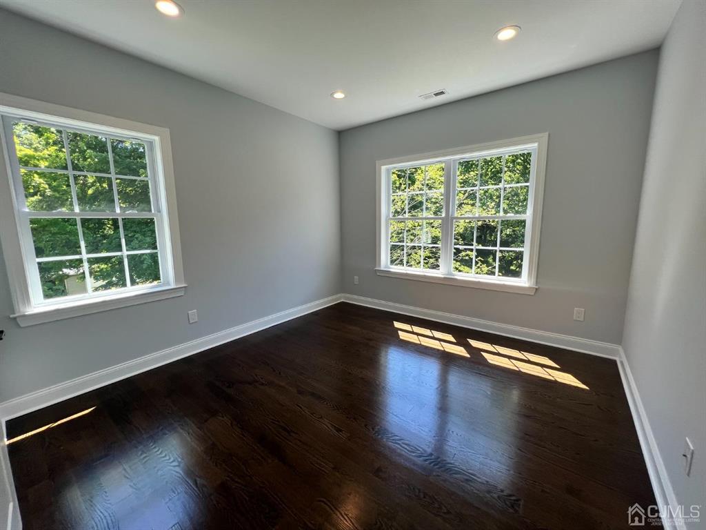 133 Old Beekman Road Monmouth Junction, NJ 08852 - Photo 17 of 42 a view of an empty room with wooden floor and a window