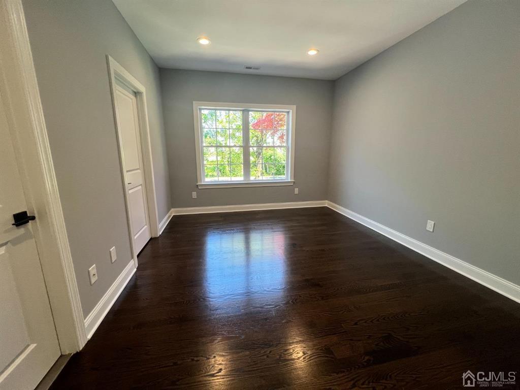 133 Old Beekman Road Monmouth Junction, NJ 08852 - Photo 19 of 42 an empty room with wooden floor and windows