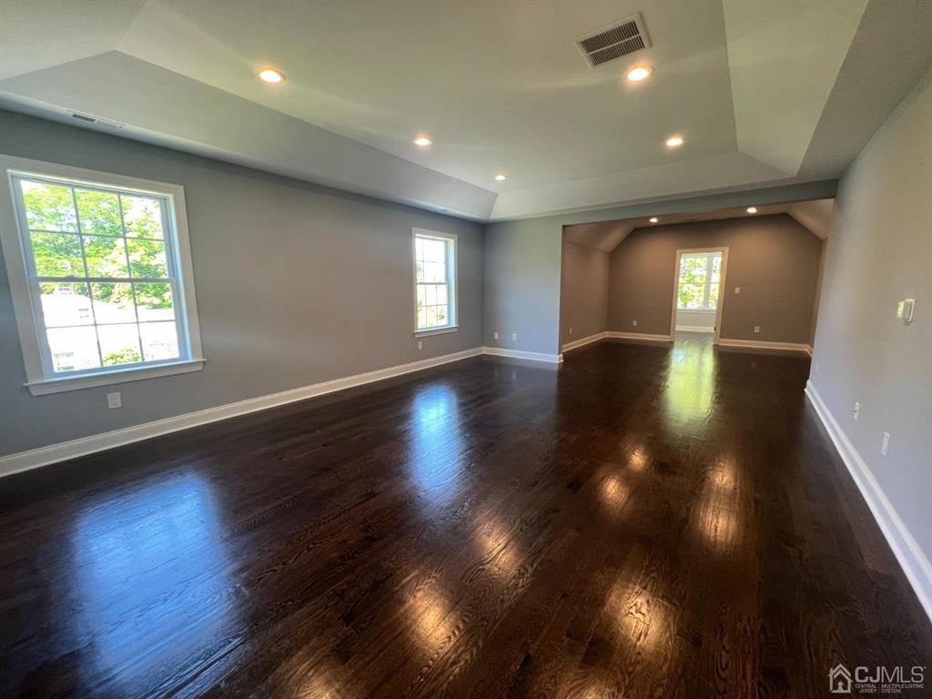 133 Old Beekman Road Monmouth Junction, NJ 08852 - Photo 23 of 42 an empty room with wooden floor and windows