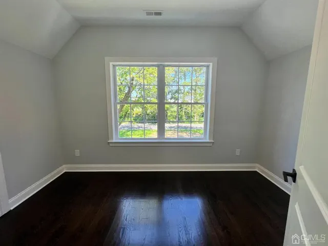 a view of a room with wooden floor and a window