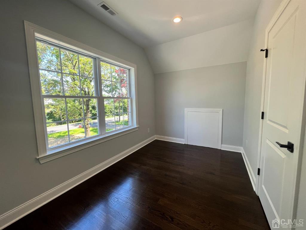 133 Old Beekman Road Monmouth Junction, NJ 08852 - Photo 27 of 42 a view of an empty room with wooden floor and a window