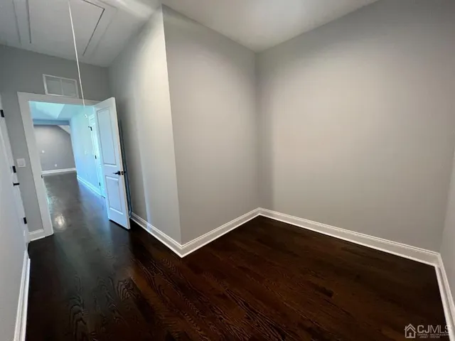 an empty room with wooden floor and wooden door